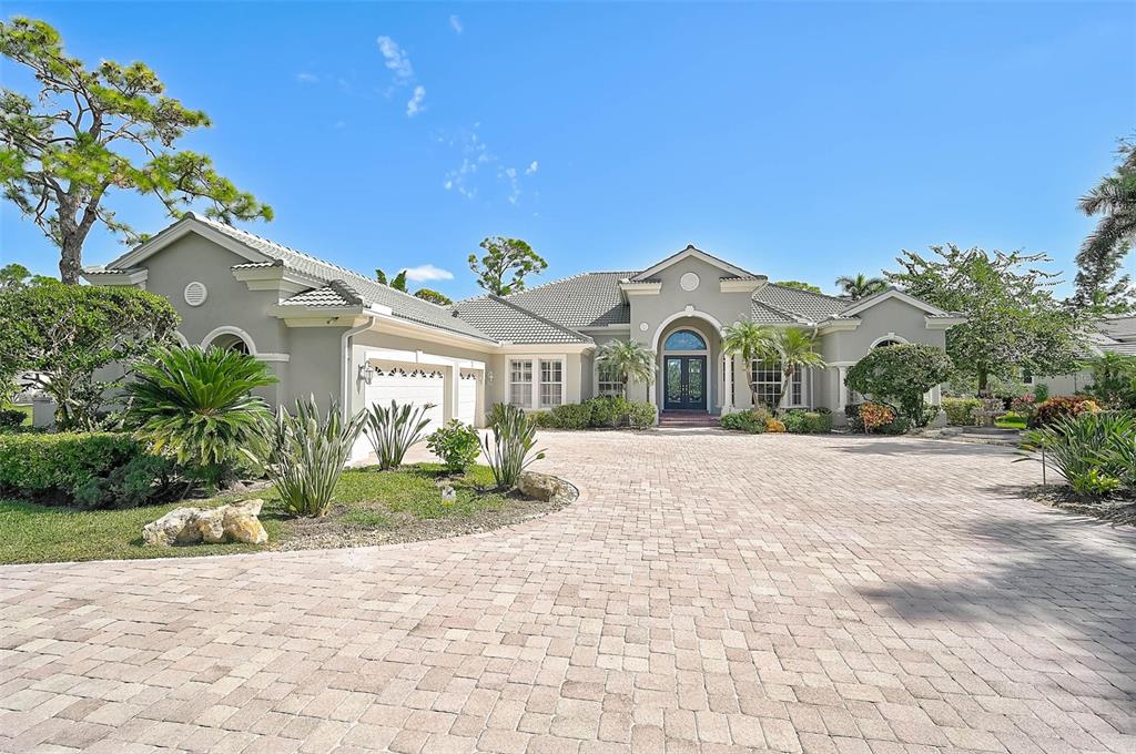 538 Dove Pointe Osprey, FL 34229 - Photo 6 of 74 a front view of a house with a yard and potted plants