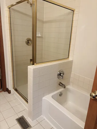 a bathroom with a tub and shower