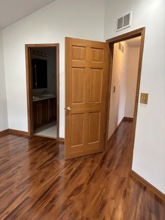 an empty room with wooden floor and closet