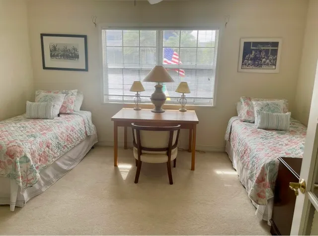 a bedroom with a bed and a table