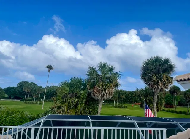 a view of a park with iron fence