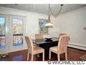 42 West Oakview Road Asheville, NC 28806 - Photo 4 of 12 a view of a dining room with furniture and wooden floor