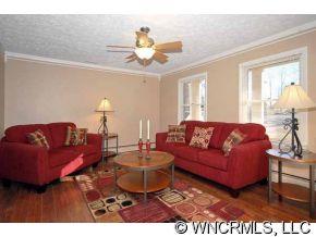 42 West Oakview Road Asheville, NC 28806 - Photo 5 of 12 a living room with furniture a chandelier and a glass door