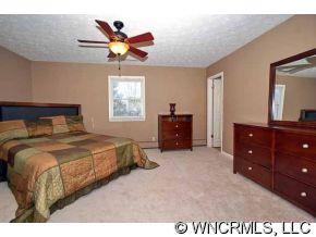 42 West Oakview Road Asheville, NC 28806 - Photo 8 of 12 a bedroom with a bed and window