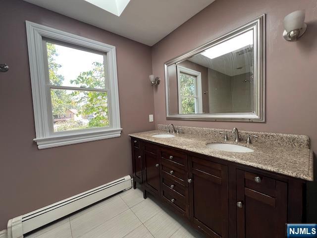 159 Henry Street Teaneck, NJ 07666 - Photo 11 of 19 a bathroom with a sink mirror and a window