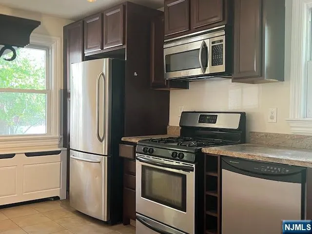 a kitchen with appliances cabinets and a counter top space