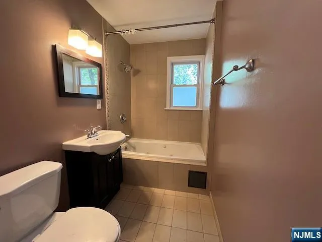 a bathroom with a sink toilet and tub