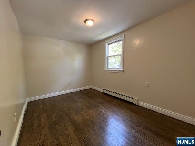 159 Henry Street Teaneck, NJ 07666 - Photo 10 of 19 an empty room with wooden floor and windows