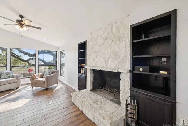 a living room with furniture and kitchen view