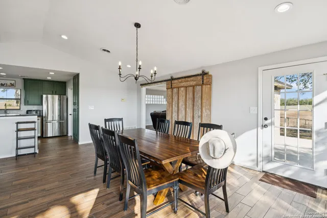 a living room with furniture a flat screen tv and a window