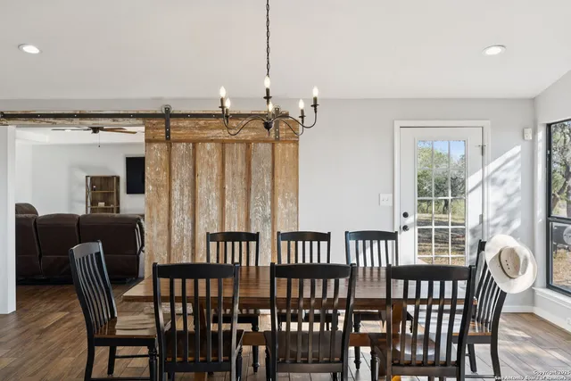 a living room with furniture a window and a book shelf