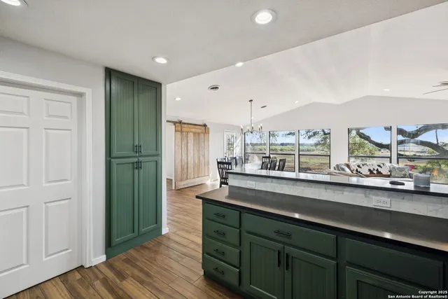 a view of a house with a yard and large tree