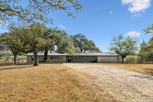 a kitchen with stainless steel appliances granite countertop a sink and a refrigerator