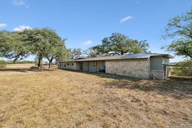 a living room with furniture a large window and a flat screen tv