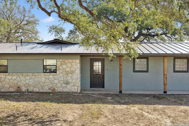 a view of a living room and kitchen with furniture wooden floor and windows