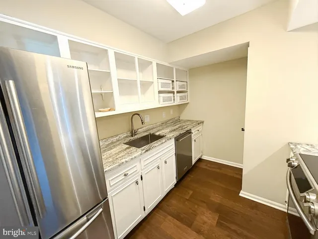 a kitchen with a refrigerator and a stove