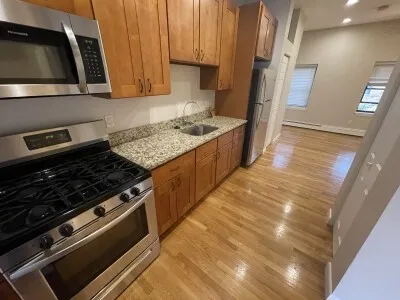a kitchen with granite countertop a stove and a sink