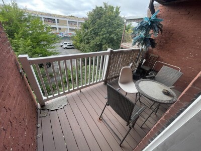 16 Pompeii Street, Unit 3 Boston, MA 02119 - Photo 7 of 7 a balcony with wooden floor table and chairs