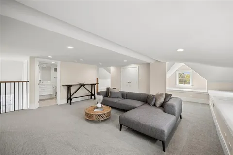a kitchen with a table chairs and wooden floor