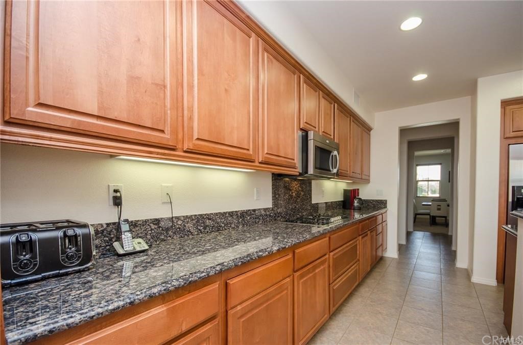 29957 Maritime Way Menifee, CA 92585 - Photo 11 of 25 a kitchen with granite countertop a sink and cabinets