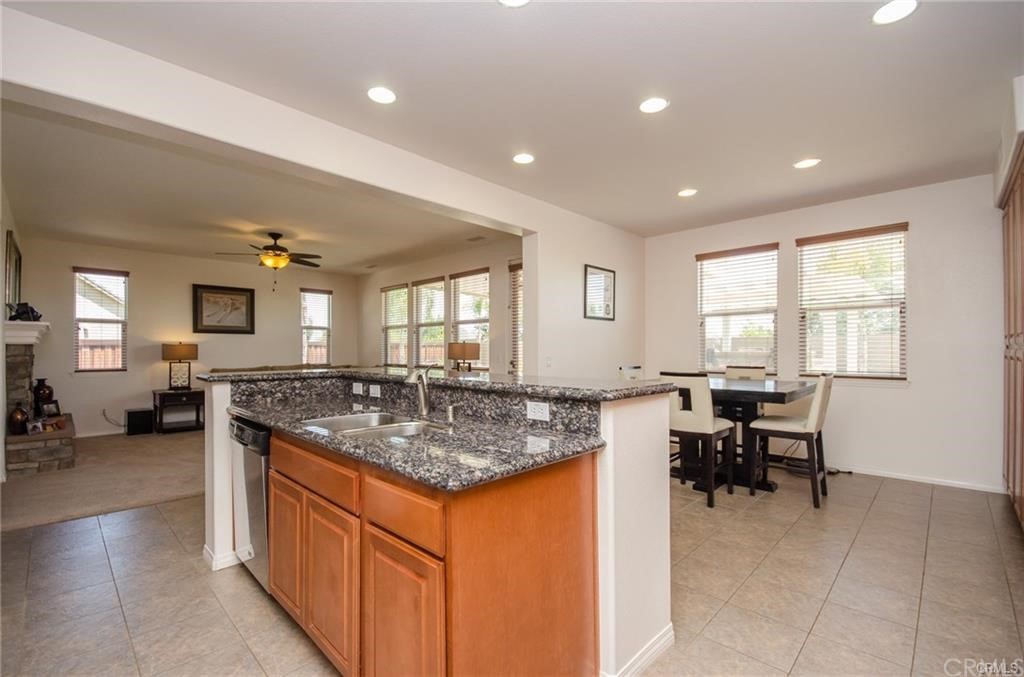 29957 Maritime Way Menifee, CA 92585 - Photo 10 of 25 a kitchen with stainless steel appliances granite countertop sink stove and table