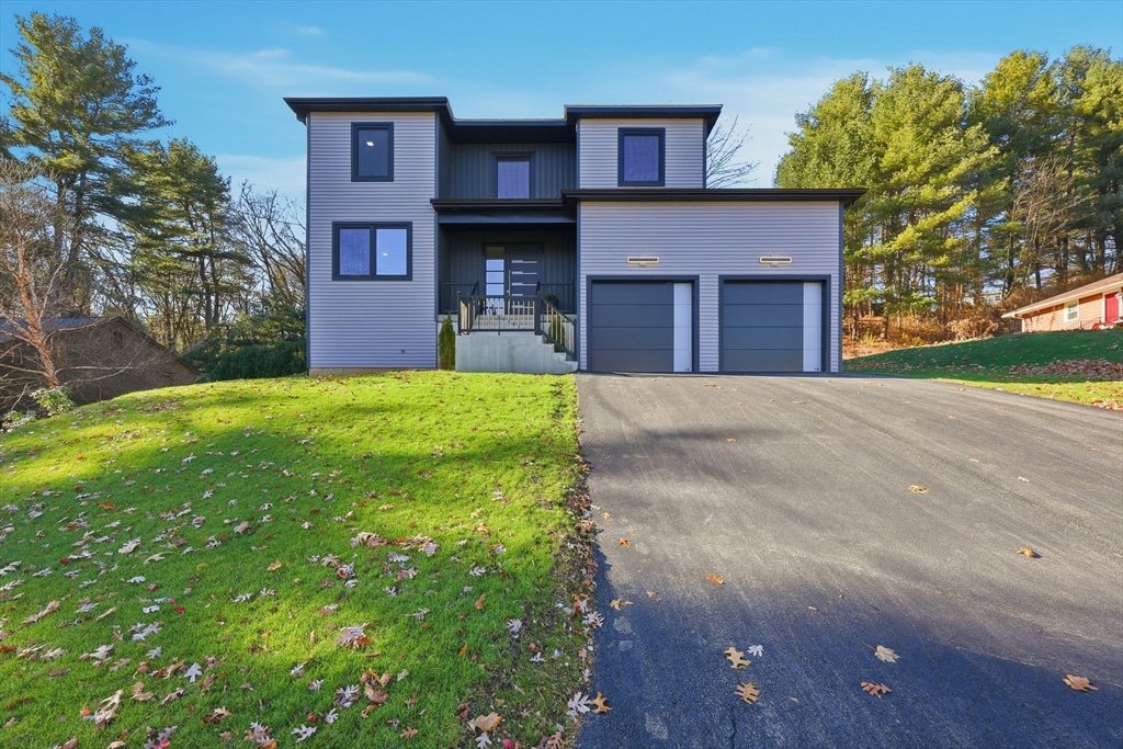 287 Whitney Avenue Holyoke, MA 01040 - Photo 1 of 40 a front view of a house with a yard and garage