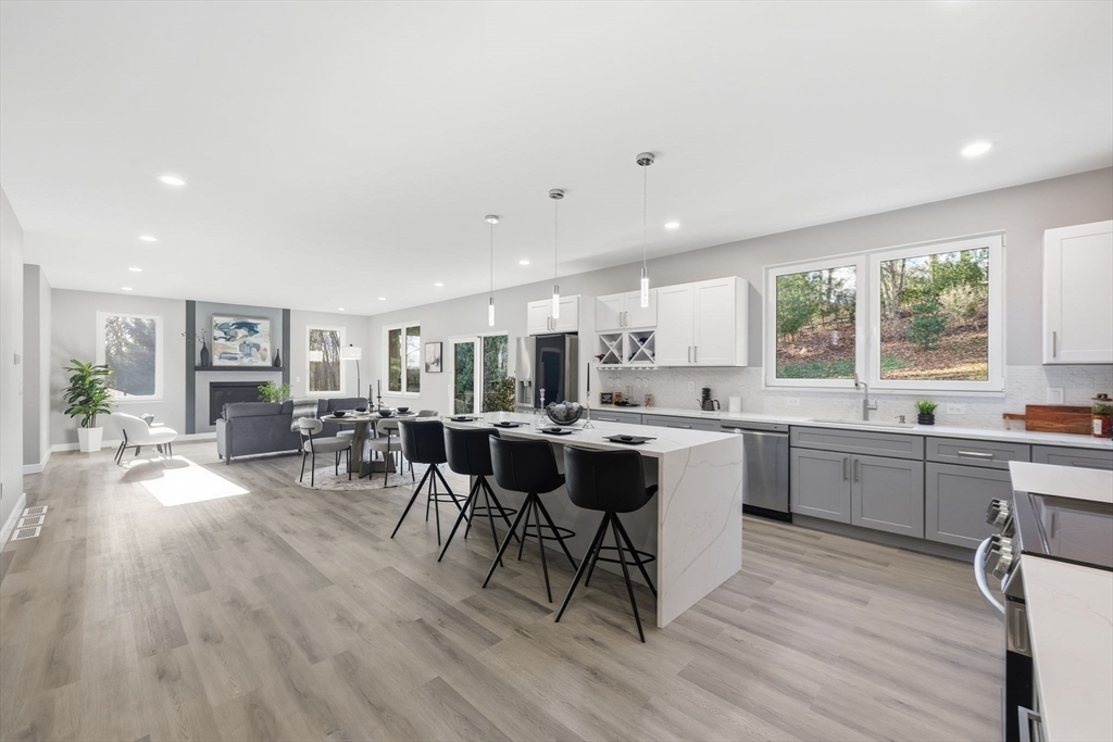 287 Whitney Avenue Holyoke, MA 01040 - Photo 12 of 40 a large kitchen with a table and chairs in it