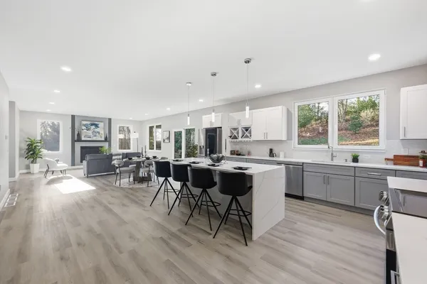 a kitchen with white cabinets and sink