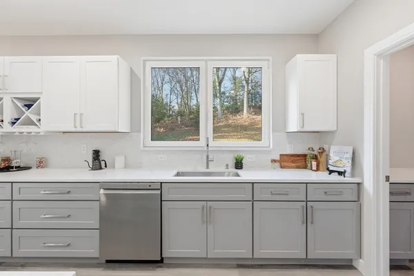 a large kitchen with a table and chairs in it