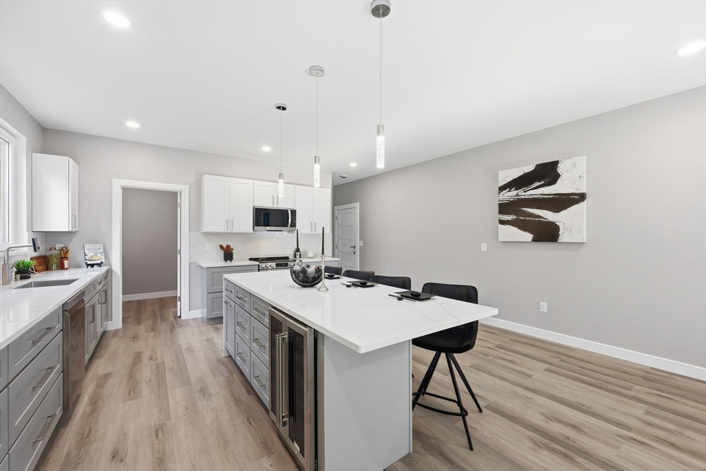 287 Whitney Avenue Holyoke, MA 01040 - Photo 14 of 40 a large kitchen with a table and chairs in it
