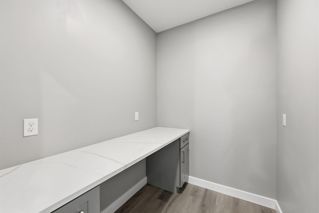 287 Whitney Avenue Holyoke, MA 01040 - Photo 18 of 40 a room with linen closet and wooden floor