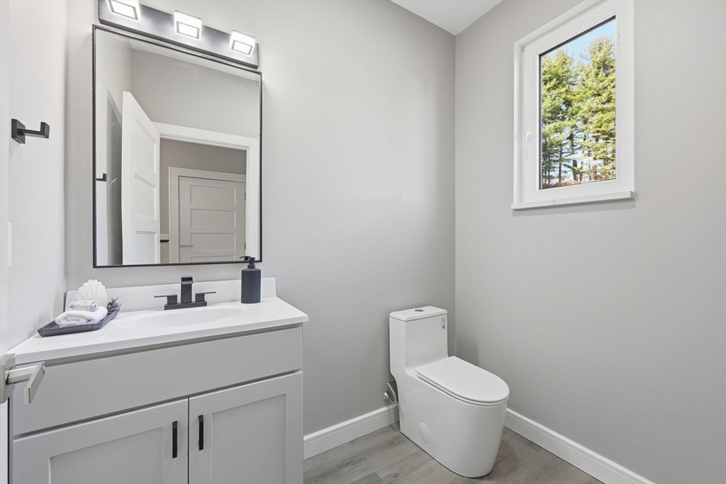 287 Whitney Avenue Holyoke, MA 01040 - Photo 19 of 40 a bathroom with a toilet sink and mirror
