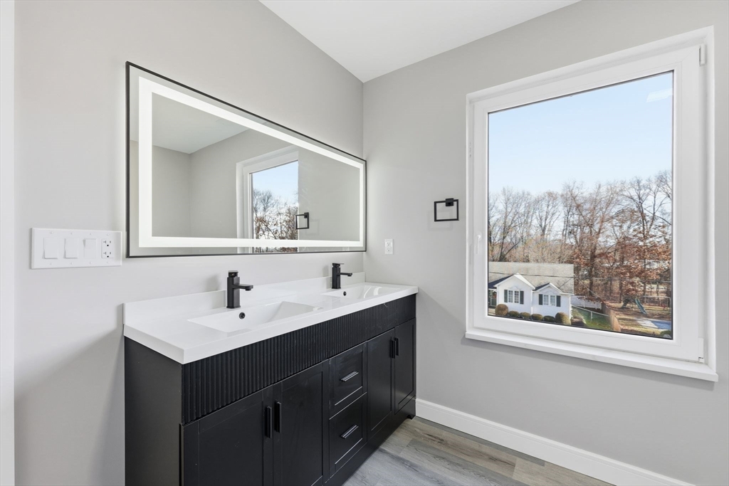 287 Whitney Avenue Holyoke, MA 01040 - Photo 29 of 40 a bathroom with 2 sink and a mirror