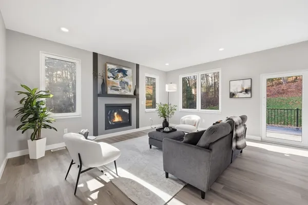 a living room with furniture a fireplace and a potted plant
