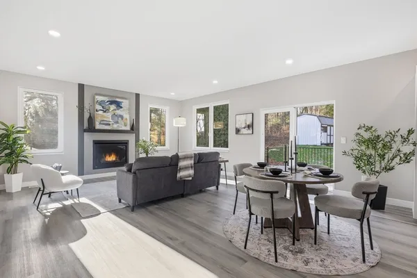 a kitchen with a table chairs refrigerator and microwave