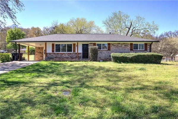 a front view of a house with a yard and porch
