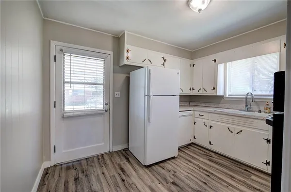 a kitchen with granite countertop cabinets appliances and a window