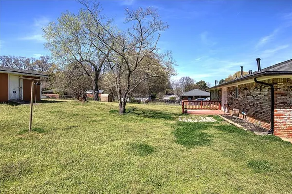 a view of a yard with a house in the background
