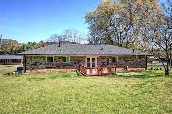 a view of a house with garden and trees