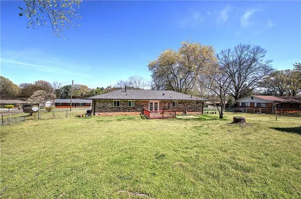 a yellow house with swimming pool in front of it