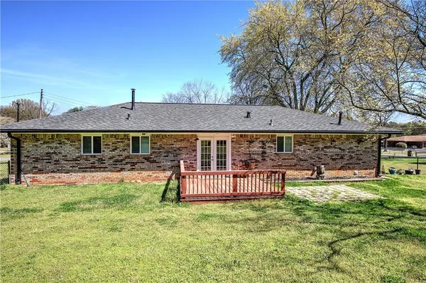 a view of house with backyard and deck