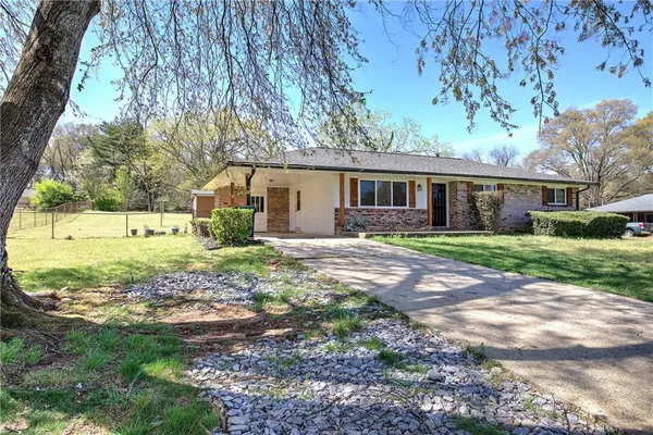 a view of house with backyard