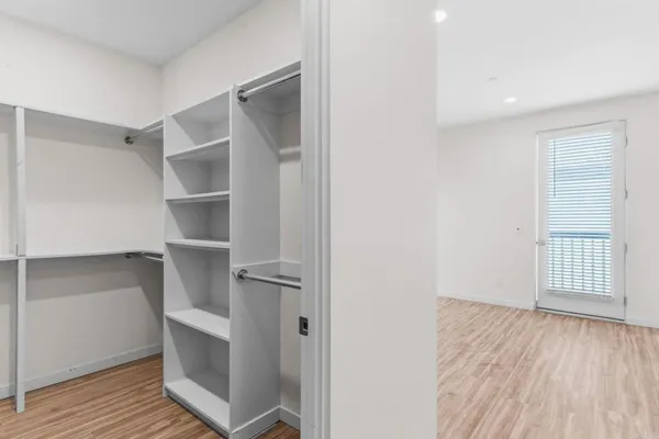 a view of walk in closet with empty racks