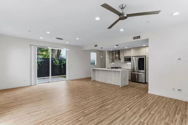 a view of kitchen with stainless steel appliances refrigerator oven and stove