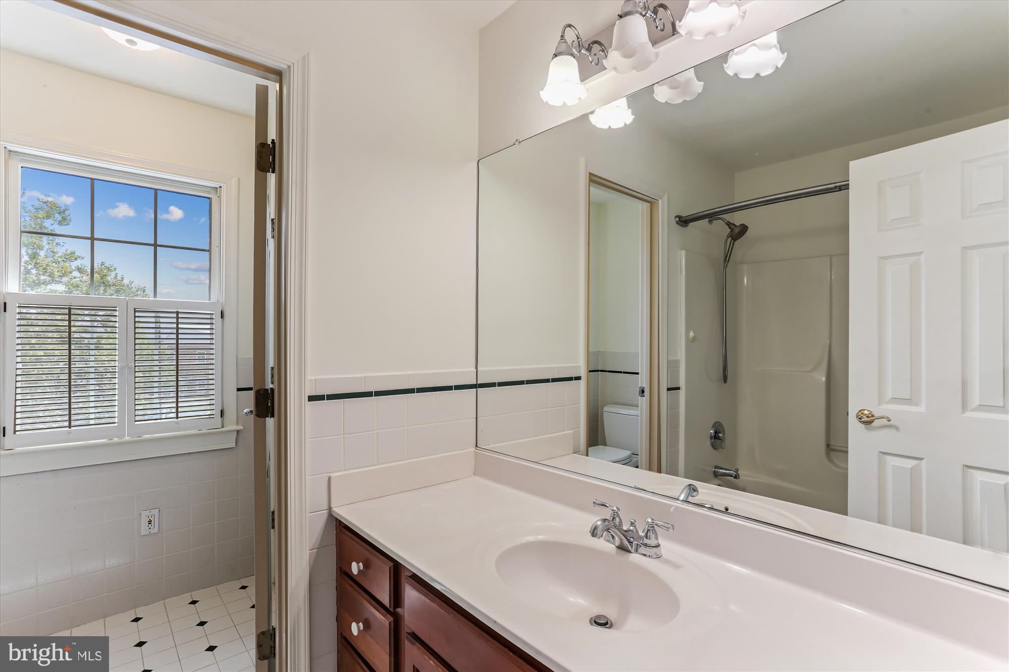 403 Kent Oaks Way Gaithersburg, MD 20878 - Photo 44 of 76 a bathroom with a sink a vanity and a mirror