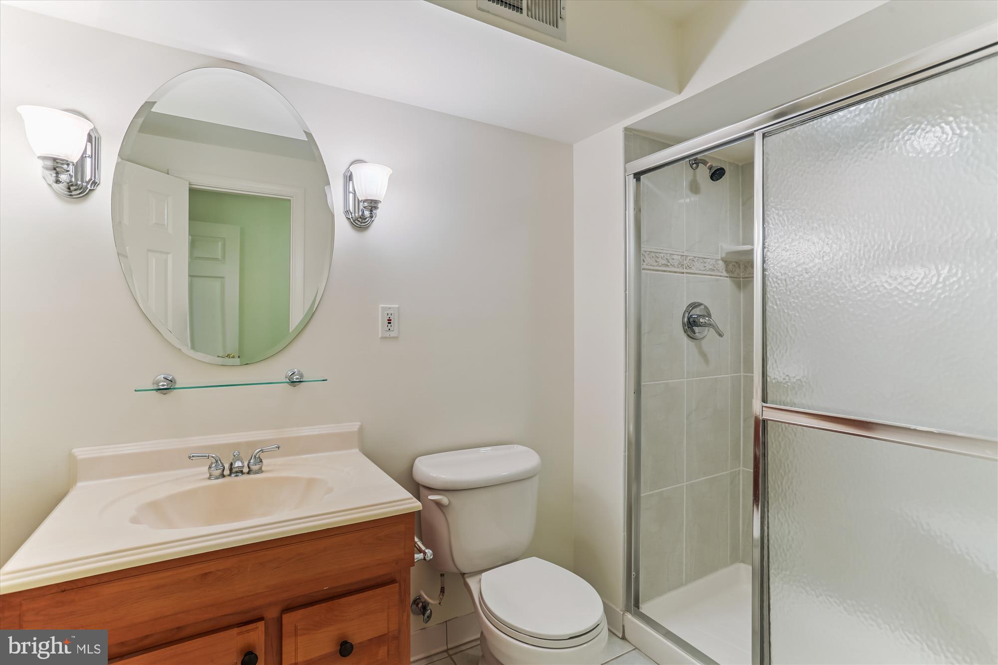 403 Kent Oaks Way Gaithersburg, MD 20878 - Photo 53 of 76 a bathroom with a sink toilet mirror and shower