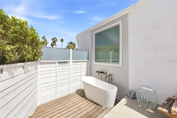 a balcony with furniture and a potted plant