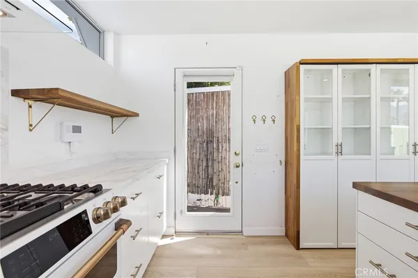 a kitchen with a stove and a wooden cabinets