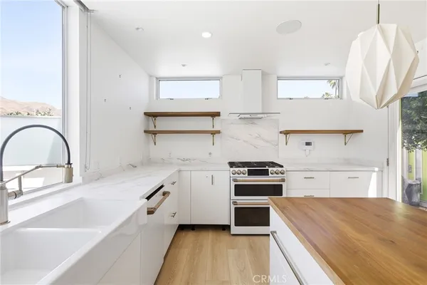 a kitchen with a stove a sink and a refrigerator