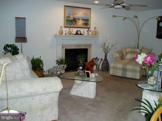 634 Surrey Road Sewell, NJ 08080 - Photo 2 of 4 a living room with furniture and a fireplace